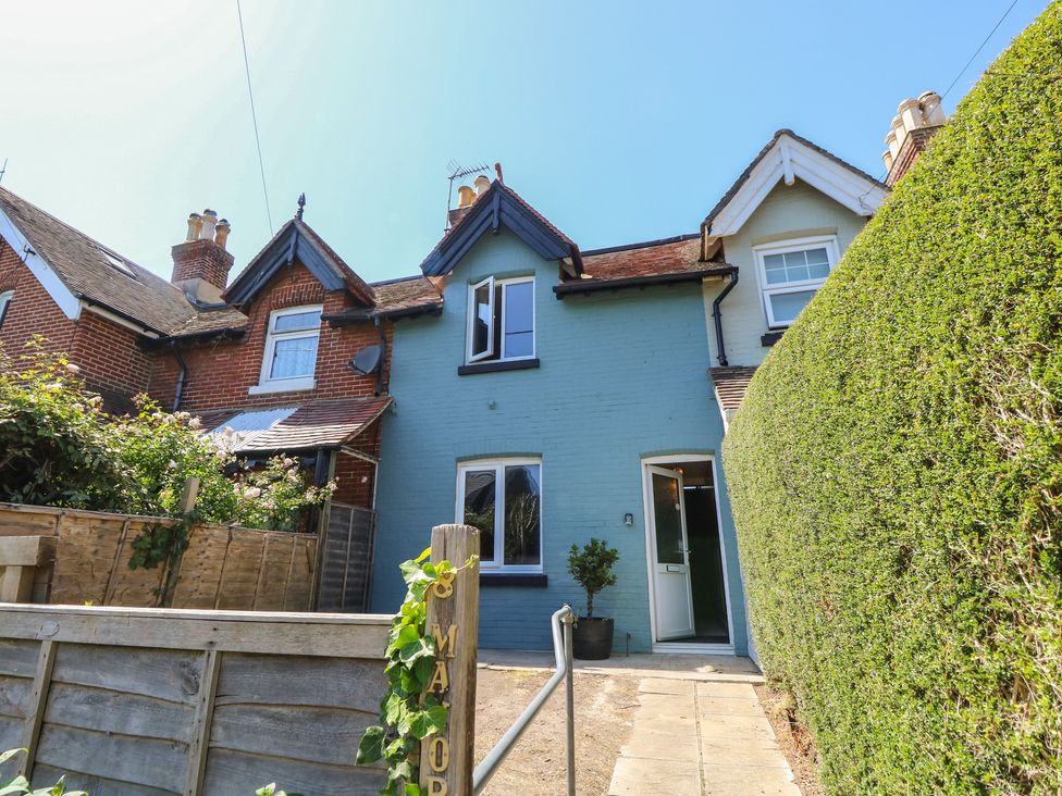 A house with windows and a door surrounded by a hedge at 8 Manor Villas Totland Bay