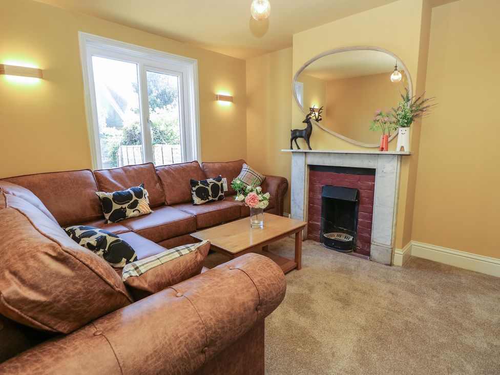A living room with a sofa and coffee table at 8 Manor Villas in Totland Bay
