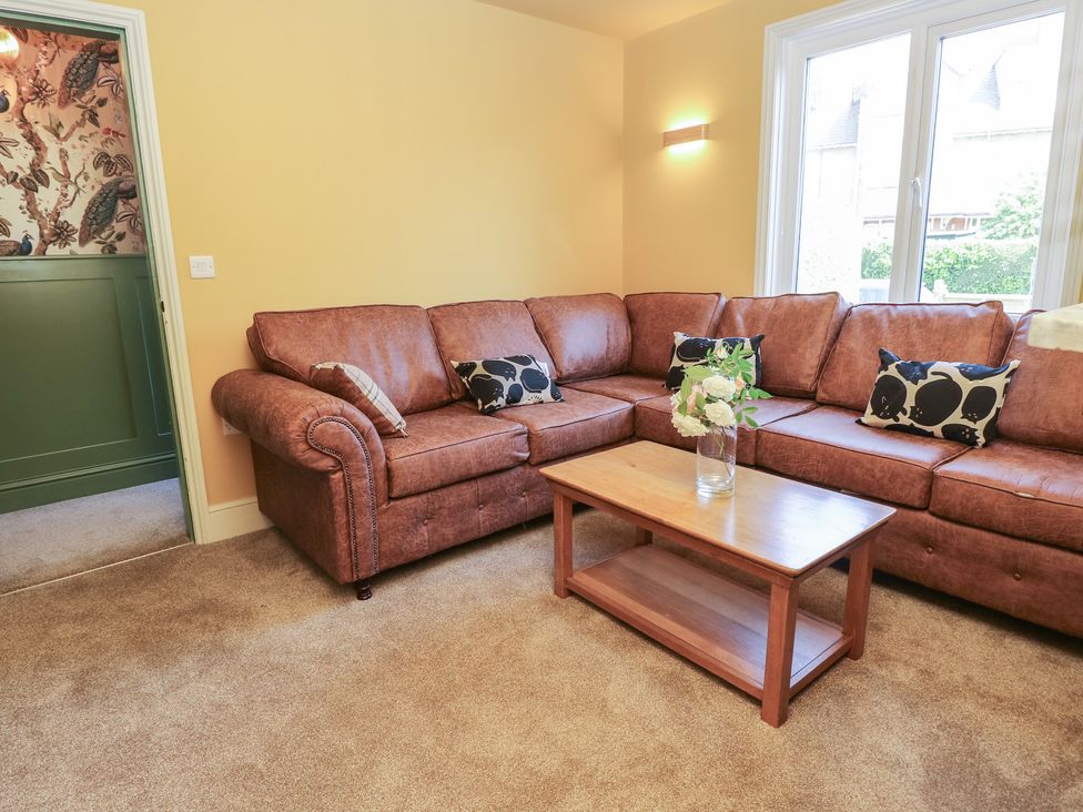 A living room with a sofa and coffee table at 8 Manor Villas in Totland Bay