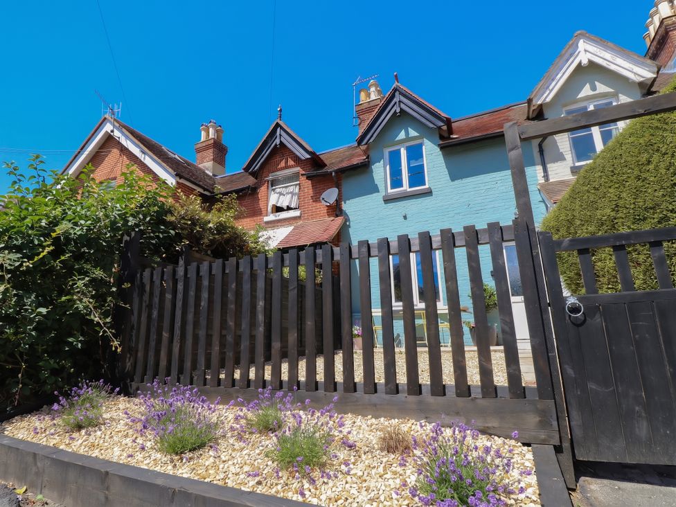 A house with a fence and lavender plants at 8 Manor Villas Totland Bay