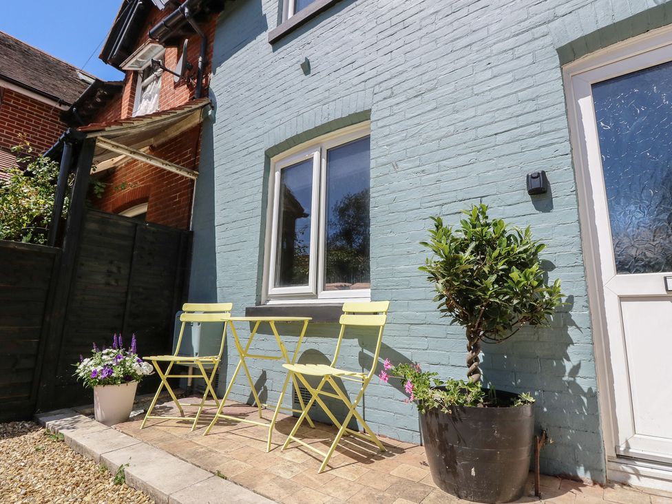 An outdoor area with a table and chairs at 8 Manor Villas in Totland Bay