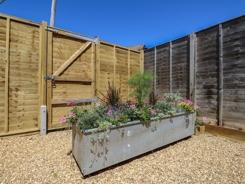 An outdoor area with a planter and flowers at 8 Manor Villas Totland Bay