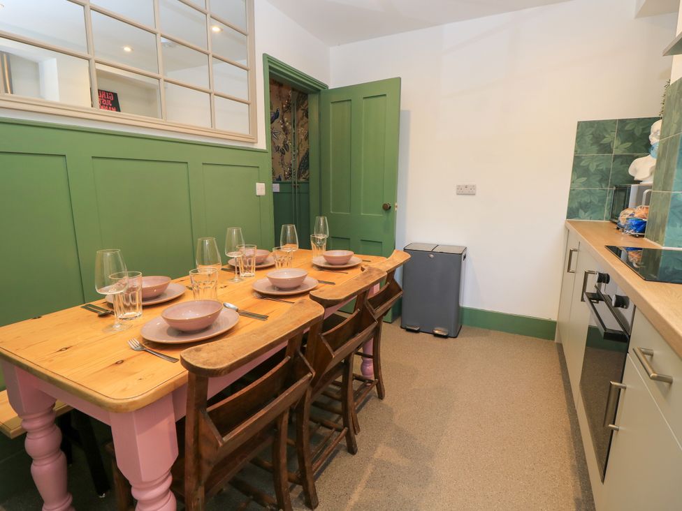 A dining room with a table and chairs at 8 Manor Villas Totland Bay