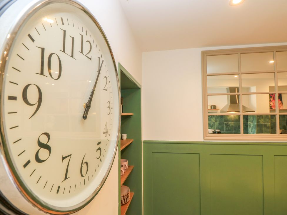 A clock and shelf in a kitchen at 8 Manor Villas Totland Bay