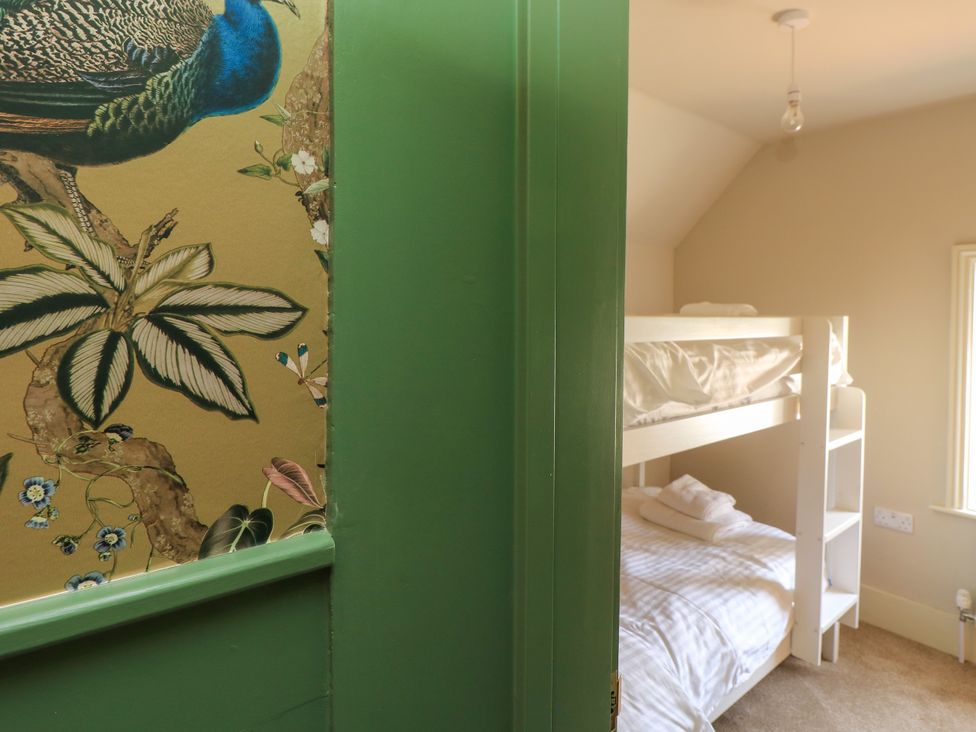 A bedroom featuring a bunk bed with bedding at 8 Manor Villas in Totland Bay