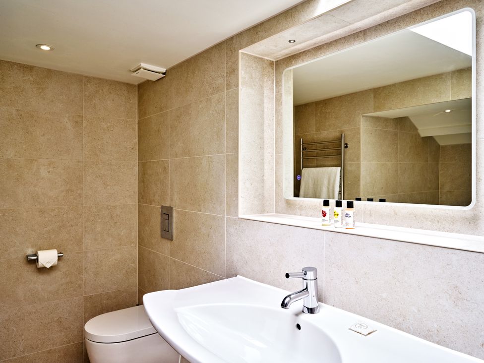 A bathroom with a sink and toilet at Gitcombe Coach House in Totnes