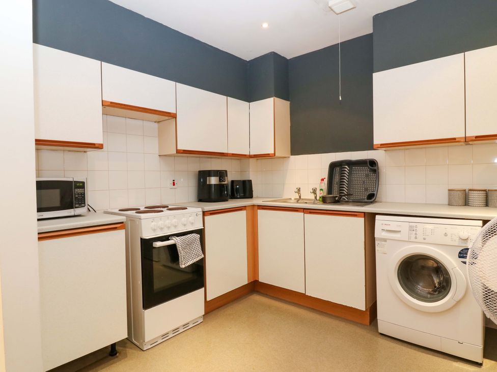A kitchen with appliances and fixtures at Apartment 1 Dyce