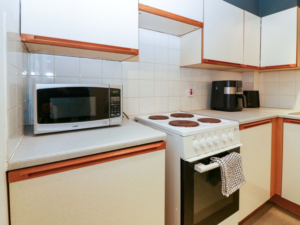 A kitchen with a microwave and stove at Apartment 1 in Dyce