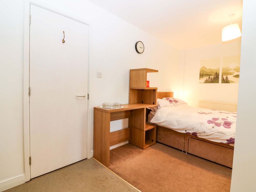 A bedroom with a bed and wall art at Apartment 1 in Dyce
