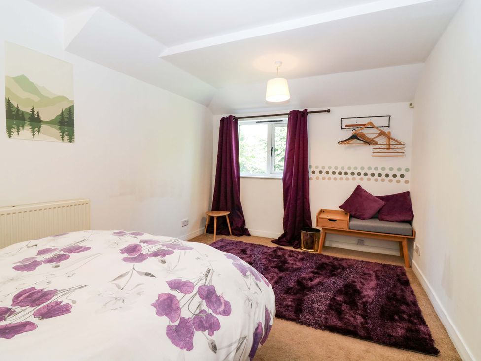 A bedroom with a bed and a window at Apartment 1 in Dyce