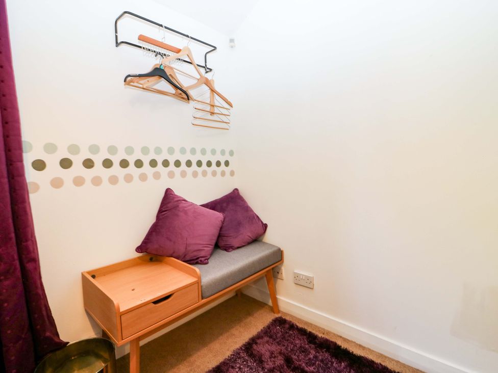 A seating area with cushions and a storage drawer at Apartment 1 in Dyce