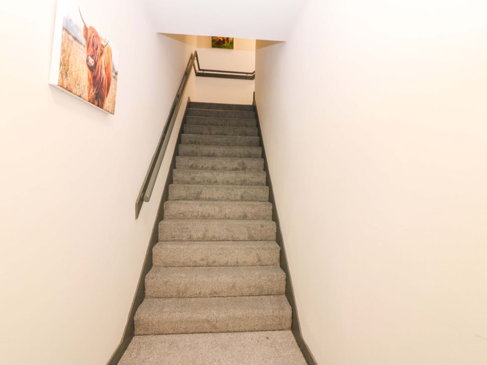 A staircase with a handrail and painting at Apartment 1 in Dyce