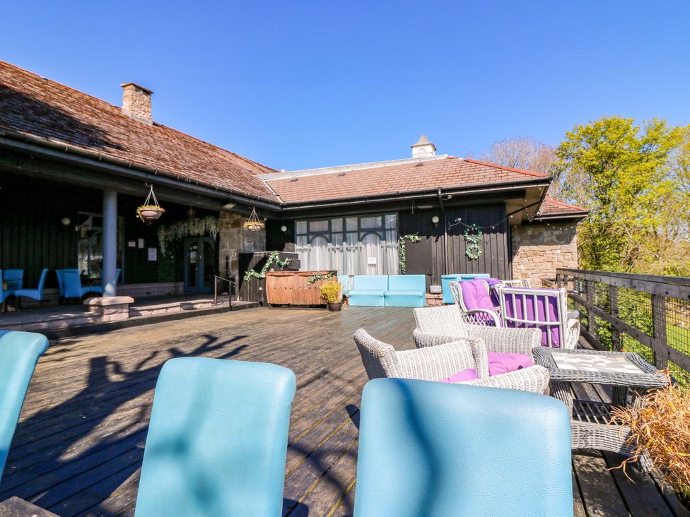 An outdoor seating area with colorful chairs at Apartment 1 in Dyce