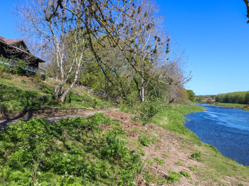 A river with trees and a path beside a house at Apartment 1 in Dyce