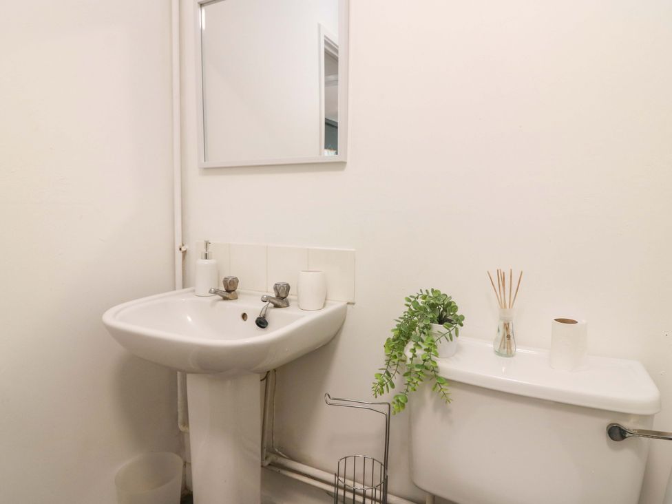 A bathroom with a sink and toilet at Apartment 2 in Dyce