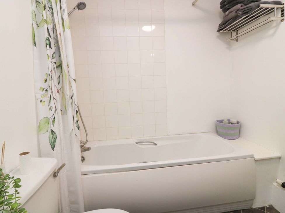 A bathroom with a bathtub and shower at Apartment 2 in Dyce