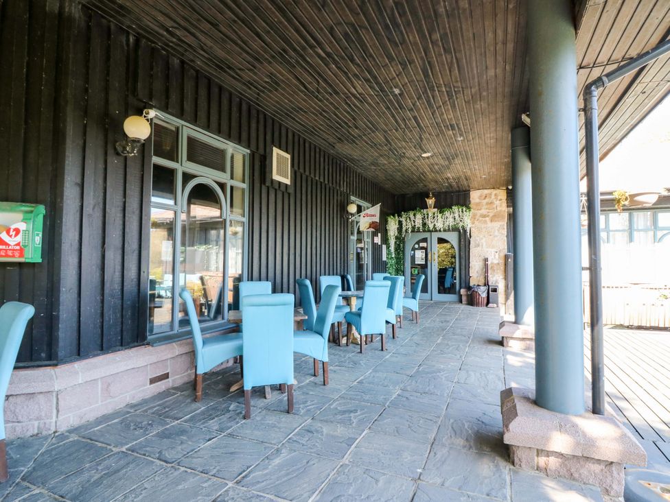 An outdoor seating area with tables and chairs at Apartment 2 in Dyce