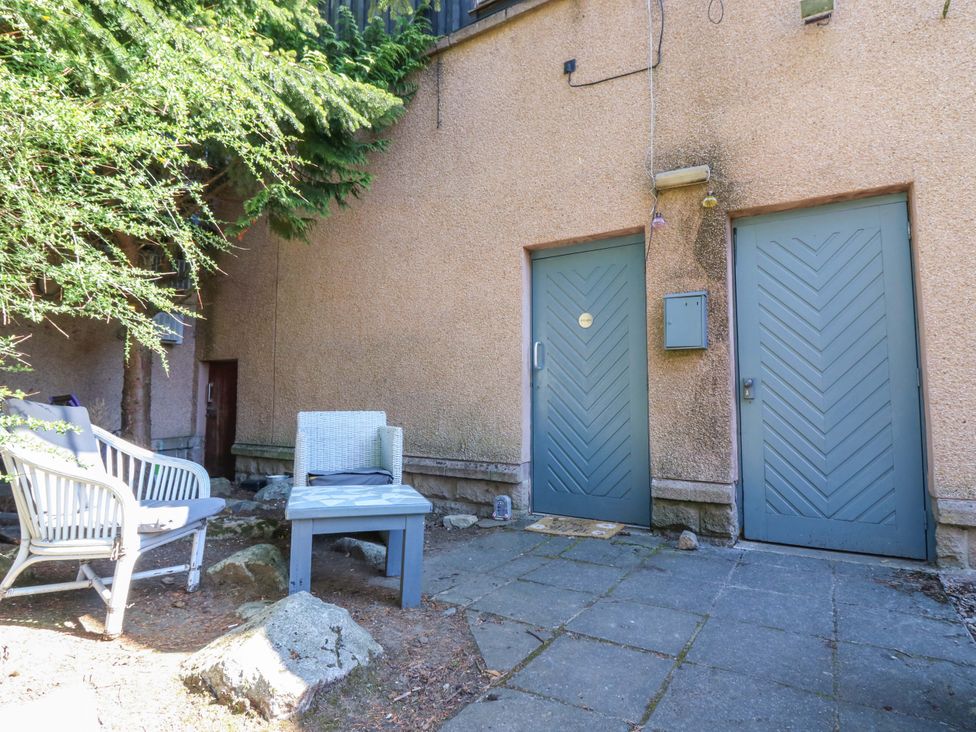 A garden with doors and a seating area at Apartment 2 in Dyce
