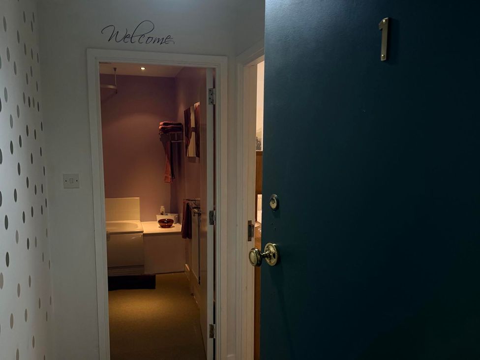 A bathroom with a toilet and towels at Apartment 3 in Dyce