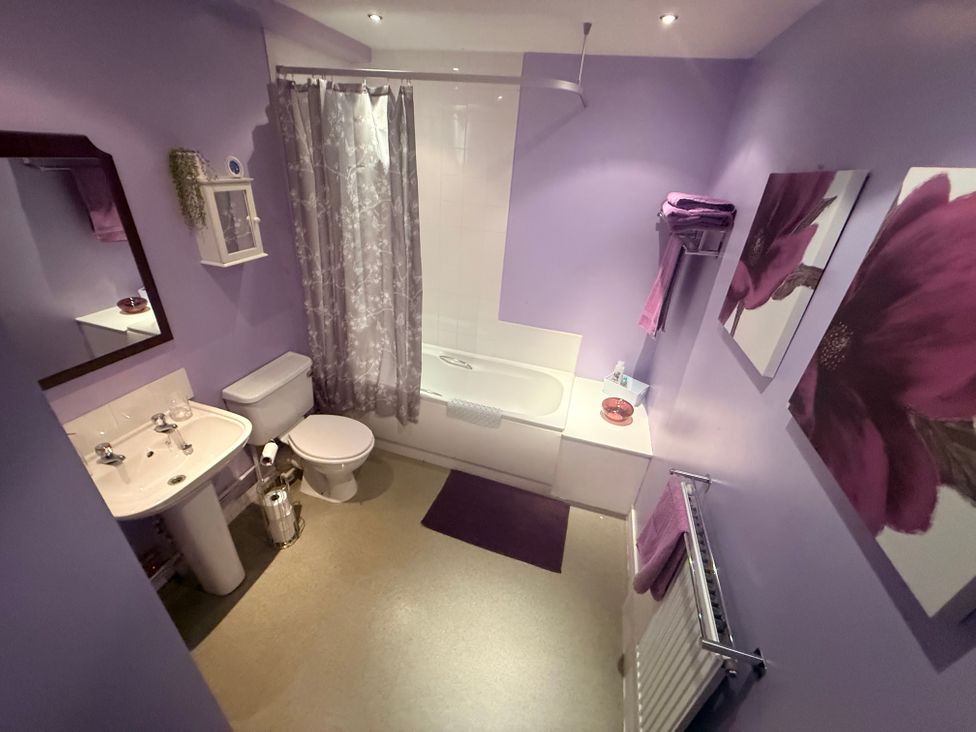 A bathroom with a bathtub and sink at Apartment 3 in Dyce