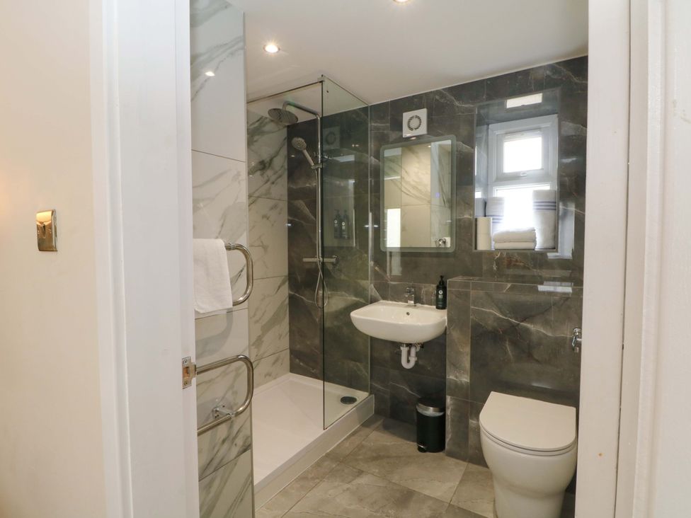 A bathroom with a shower, sink, and toilet at 1 bed no. 2 in Chorley