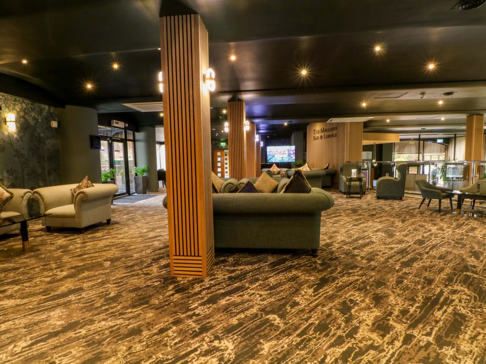 A lounge area with seating and a bar at 1 bed no. 2, Chorley