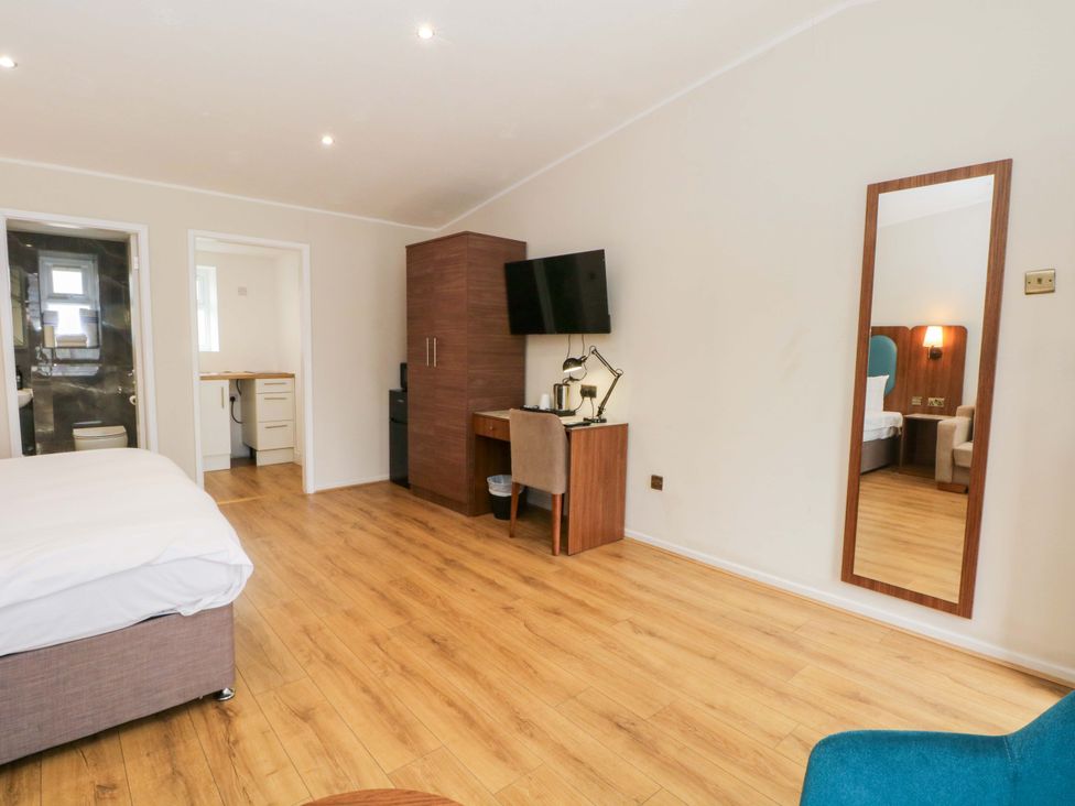 A bedroom with a bed and desk at 1 bed no.5 Chorley