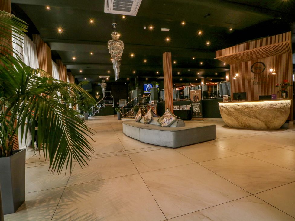 A lobby with a reception desk and seating area at 1 bed no.5 in Chorley