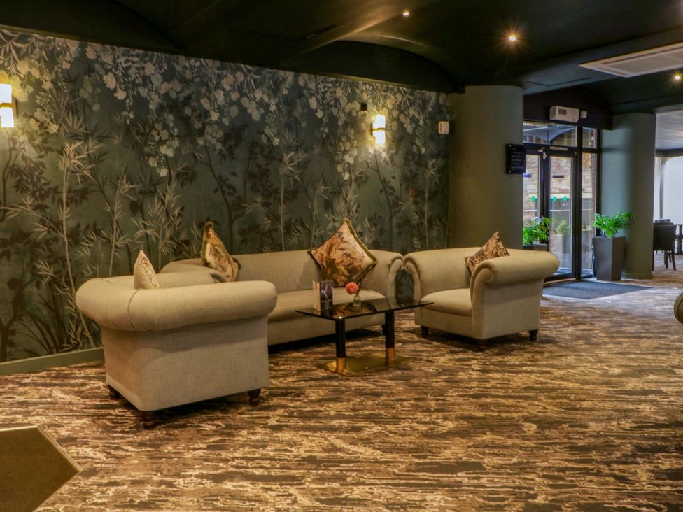 A lounge with a sofa and table at 2 bed no. 2 in Chorley