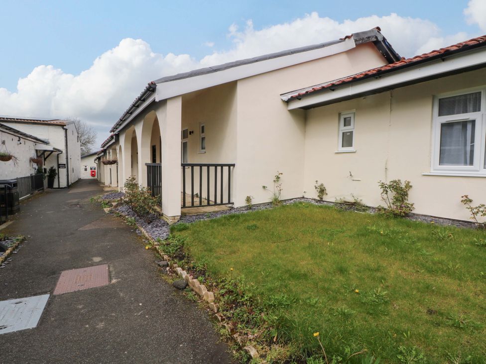 An exterior view of a building with a pathway and green grass at 2 bed no. 3 Chorley