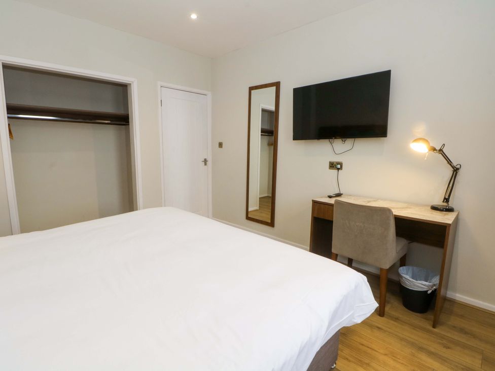 A bedroom with a bed and desk at 2 bed no. 4 in Chorley