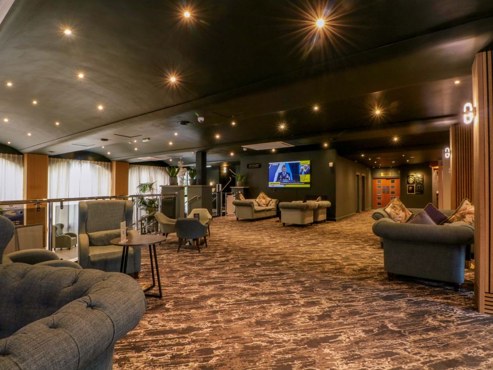 A lounge with sofas and a television at 2 bed no. 5 Chorley