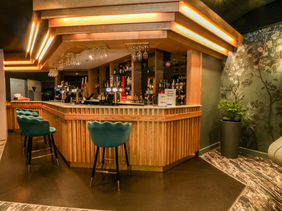 A bar area with stools and a counter at 2 bed no. 6 Chorley