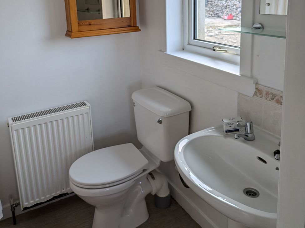 A bathroom with a toilet and hand basin at Rousey Cottage in Rousay, Orkney Islands