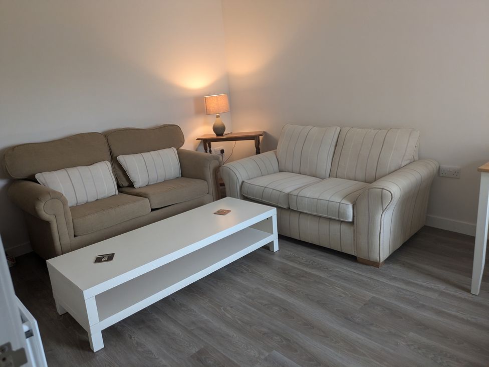 A living room with two sofas and a coffee table at Lower Hammerfield Rousay, Orkney Islands