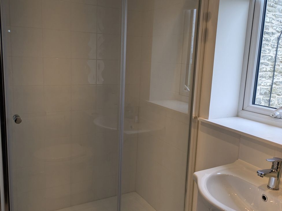 A bathroom with a shower and sink at Lower Hammerfield in Rousay, Orkney Islands