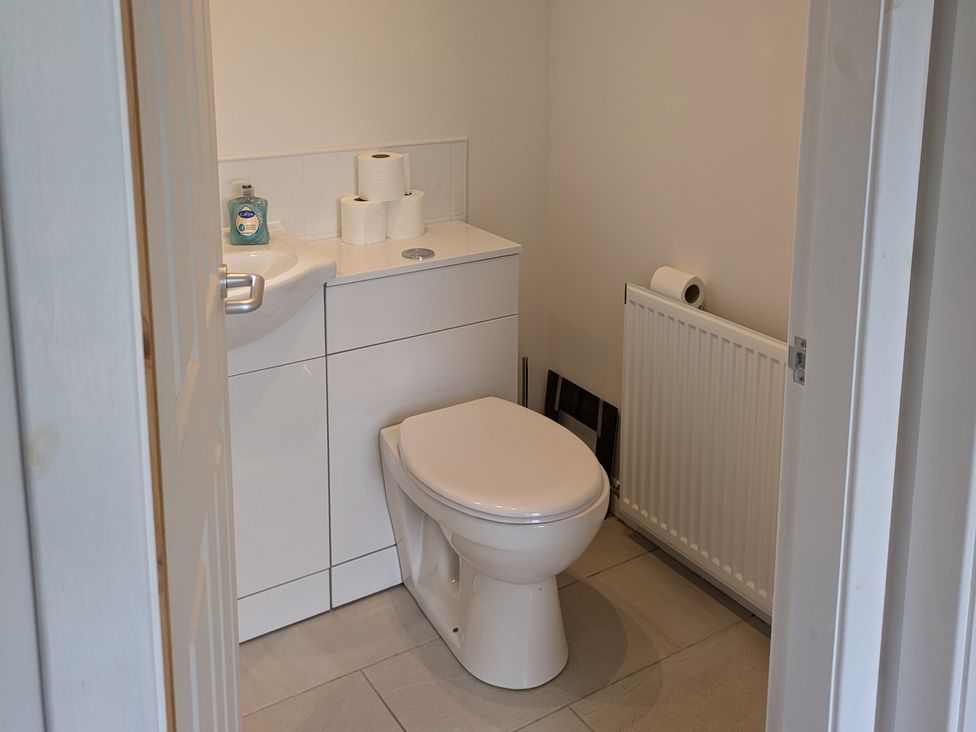 A bathroom with a toilet and sink at Lower Hammerfield, Rousay, Orkney Islands