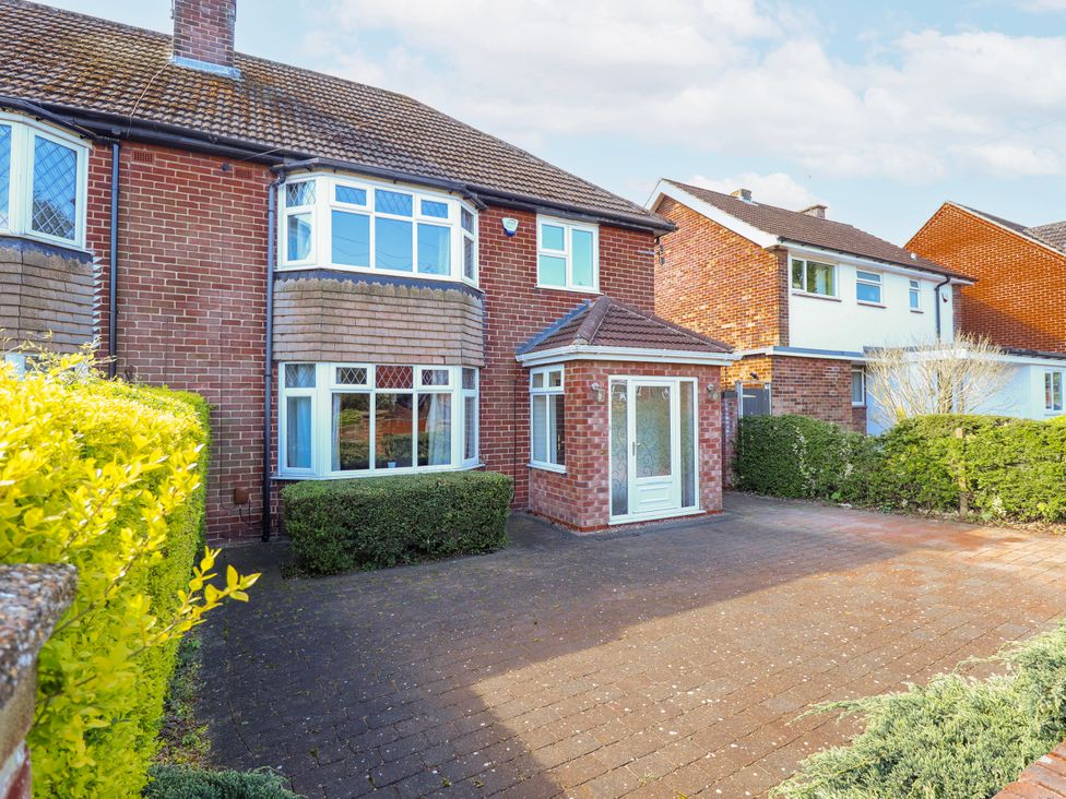A house with a driveway and hedges at 55 Broadway in Lincoln