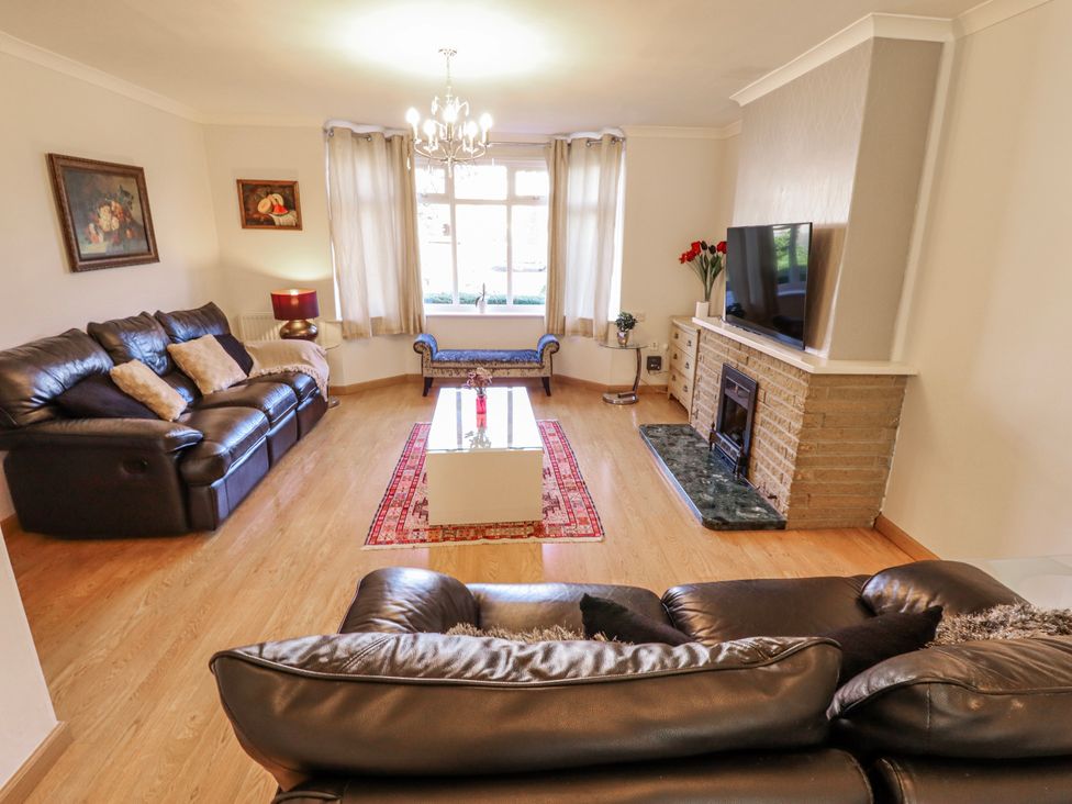 A living room with leather sofas and a coffee table at 55 Broadway in Lincoln