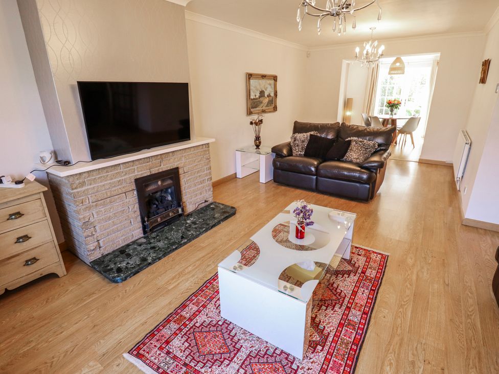 A living room with a television and a sofa at 55 Broadway in Lincoln