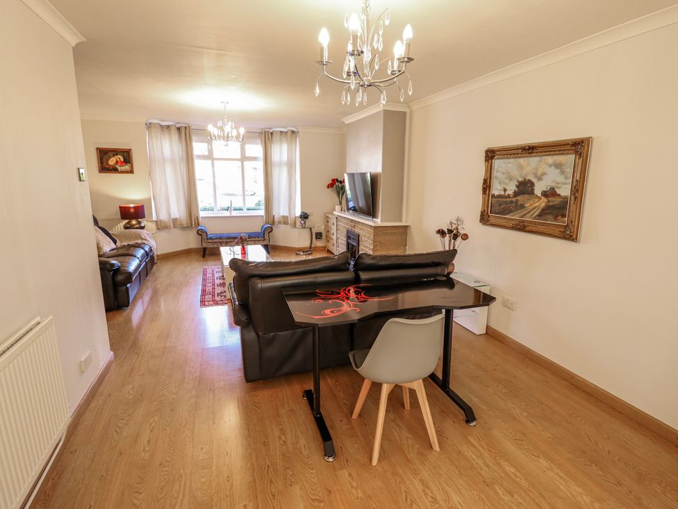 A living room with a sofa, coffee table, and television at 55 Broadway in Lincoln