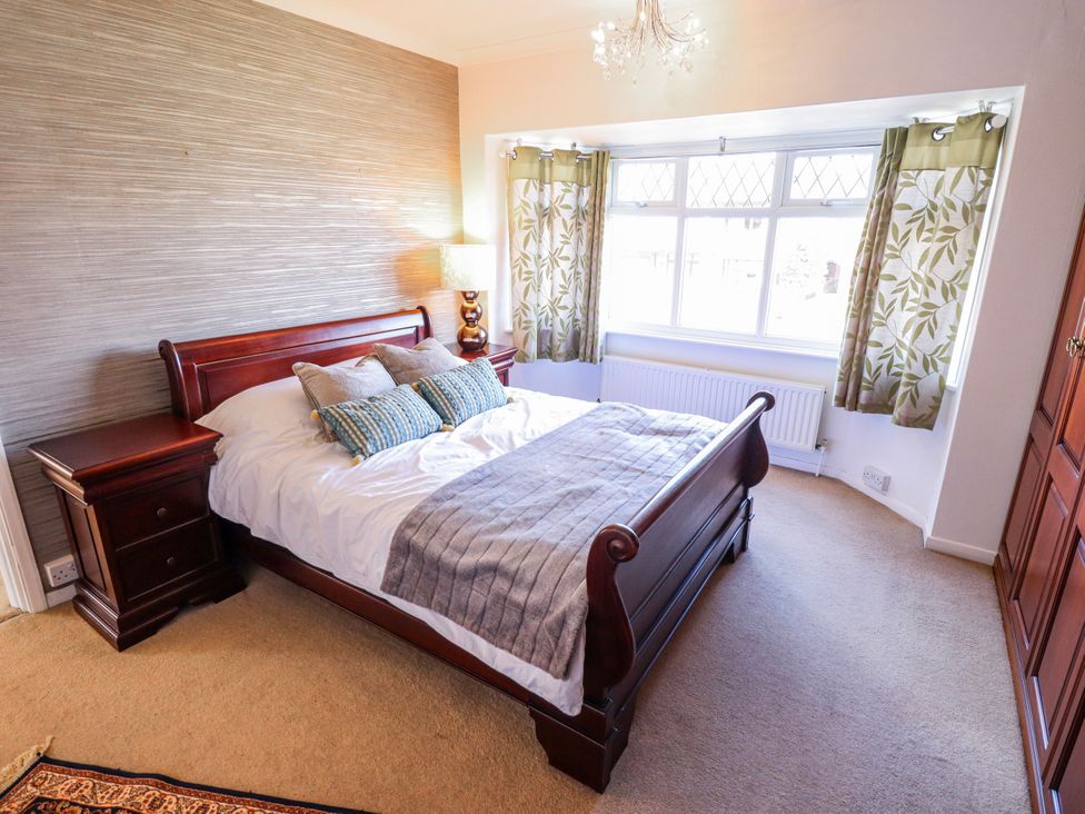 A bedroom with a bed and nightstand at 55 Broadway in Lincoln