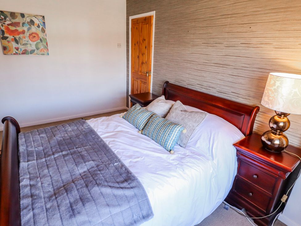 A bedroom with a bed and nightstand at 55 Broadway in Lincoln
