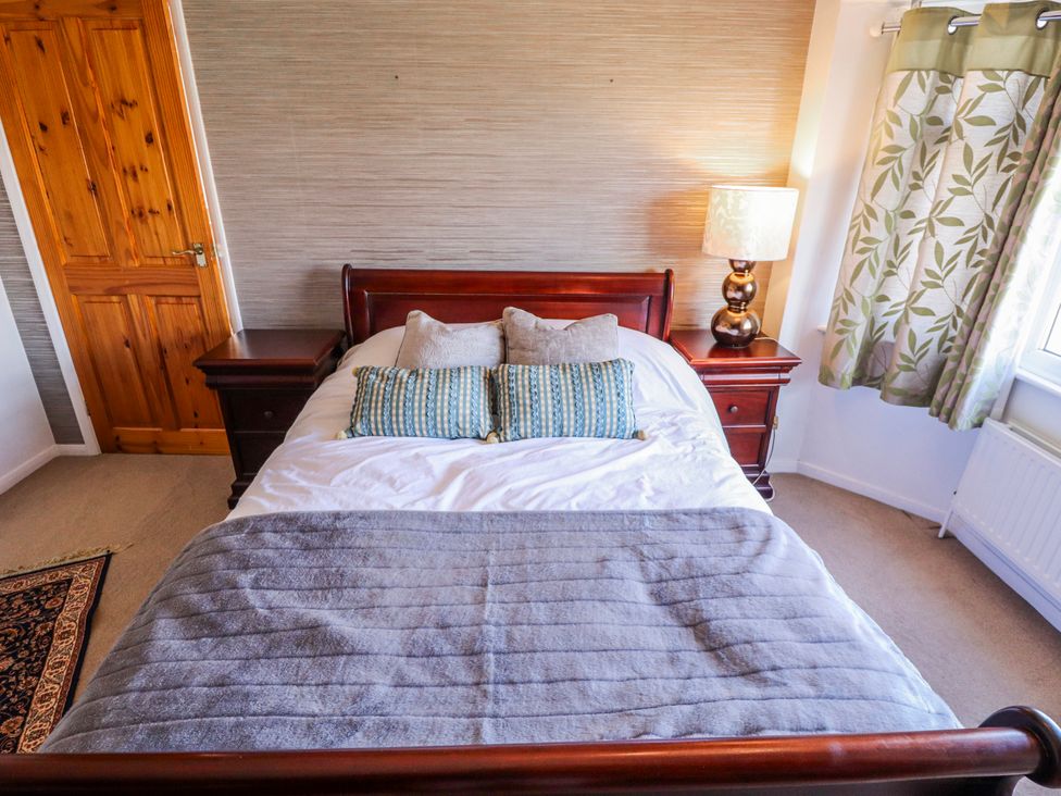 A bedroom with a bed and nightstand at 55 Broadway in Lincoln