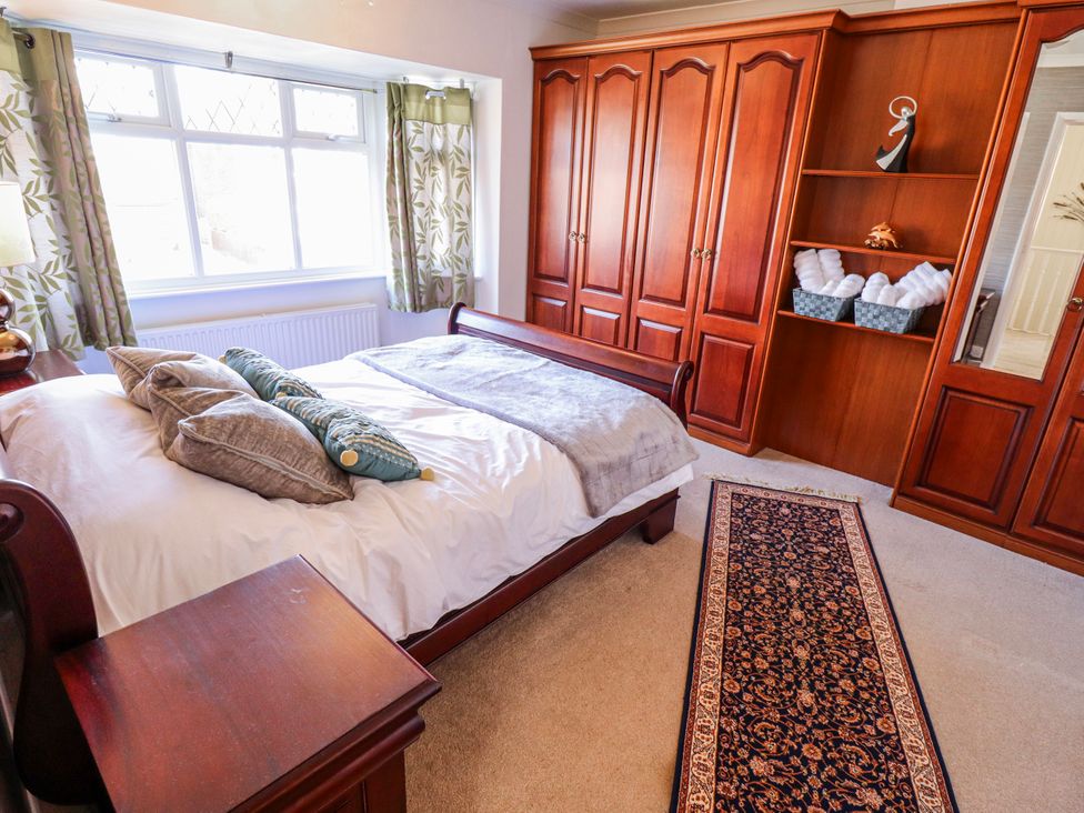 A bedroom with a bed and wardrobe at 55 Broadway in Lincoln