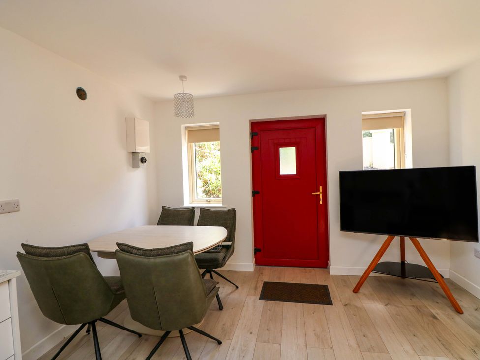 A dining room with a table and chairs at The Mews @ Suskar, Laragh, County Wicklow