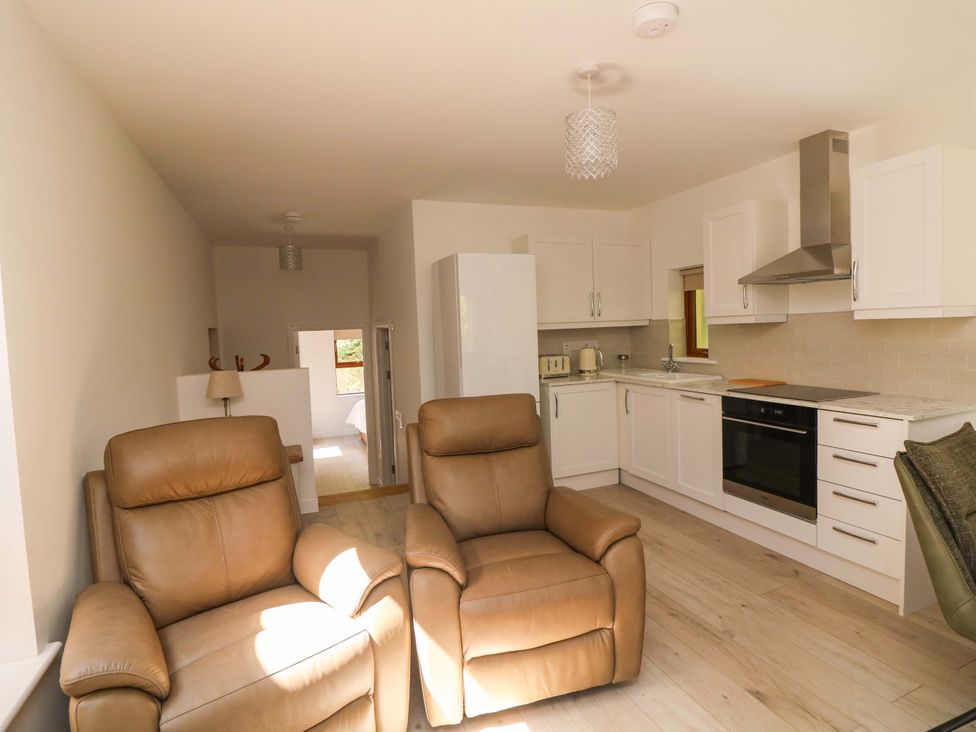 A kitchen with recliner chairs and modern appliances at The Mews @ Suskar in Laragh, County Wicklow