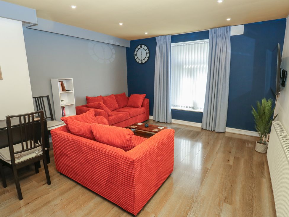 A living room with sofas and a table at No.1 Spa Mill Lodge in Huddersfield