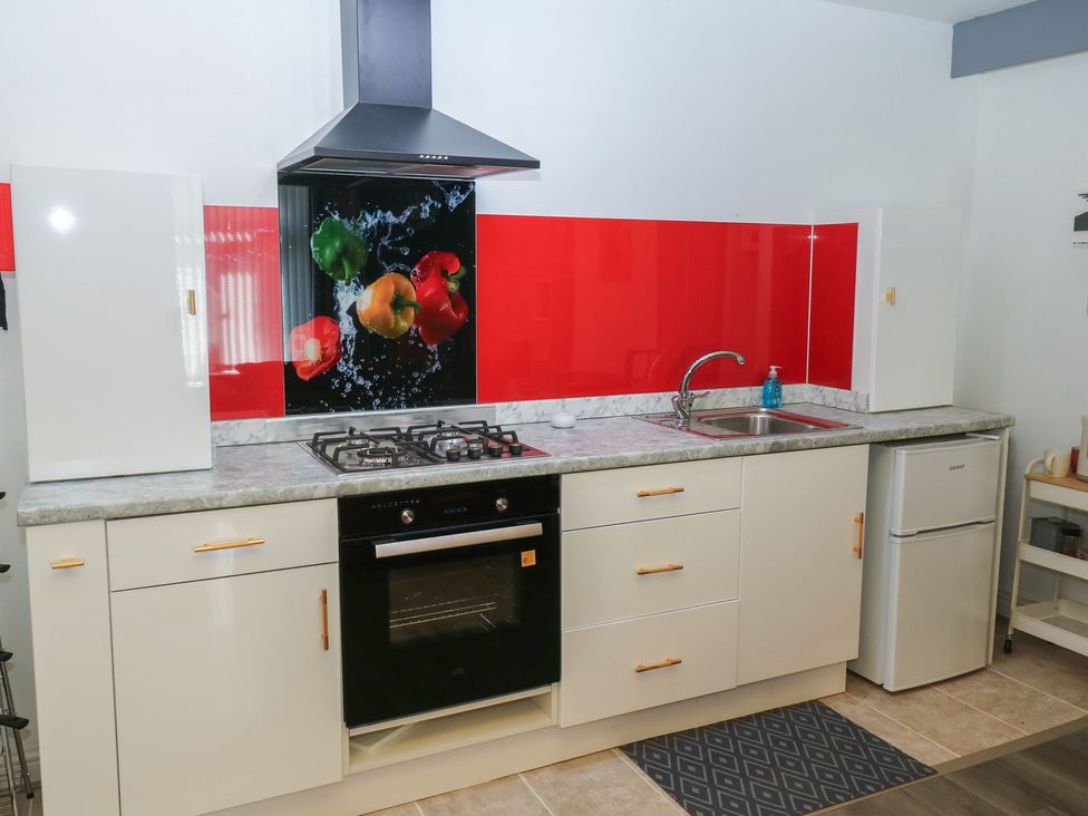 A kitchen with cabinets and appliances at No.1 Spa Mill Lodge Huddersfield