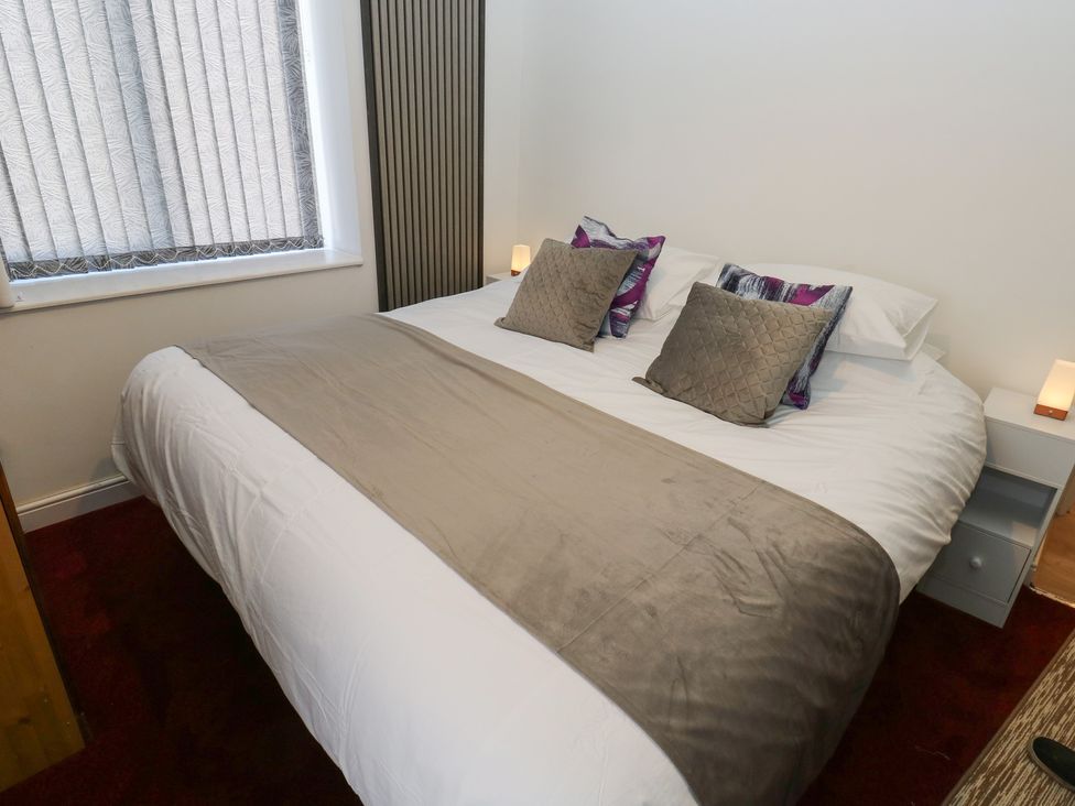 A bedroom with a bed and pillows at No.1 Spa Mill Lodge in Huddersfield